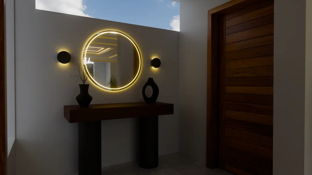 Entrance hall with circular mirror and accent lighting