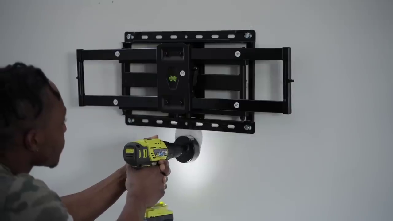 Technician installing articulating TV wall mount